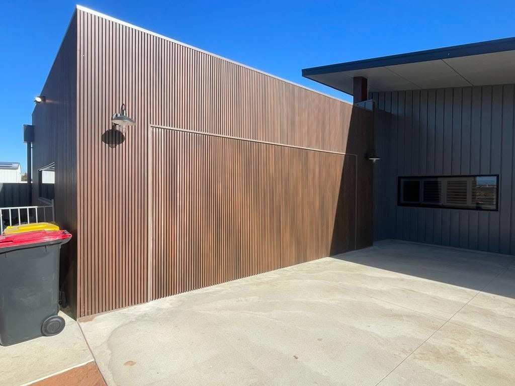 Vertical timber clad garage door on a modern build