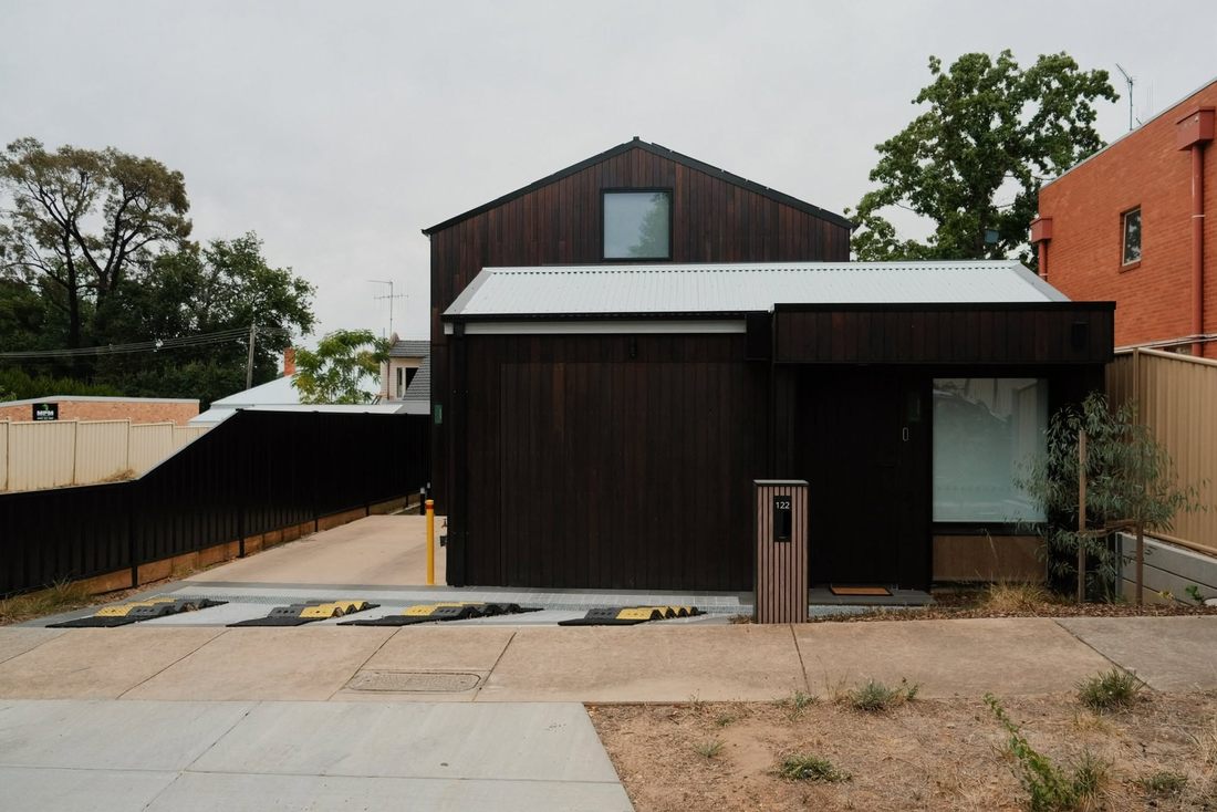 Dark stained timber sectional door on a barn style Bendigo home