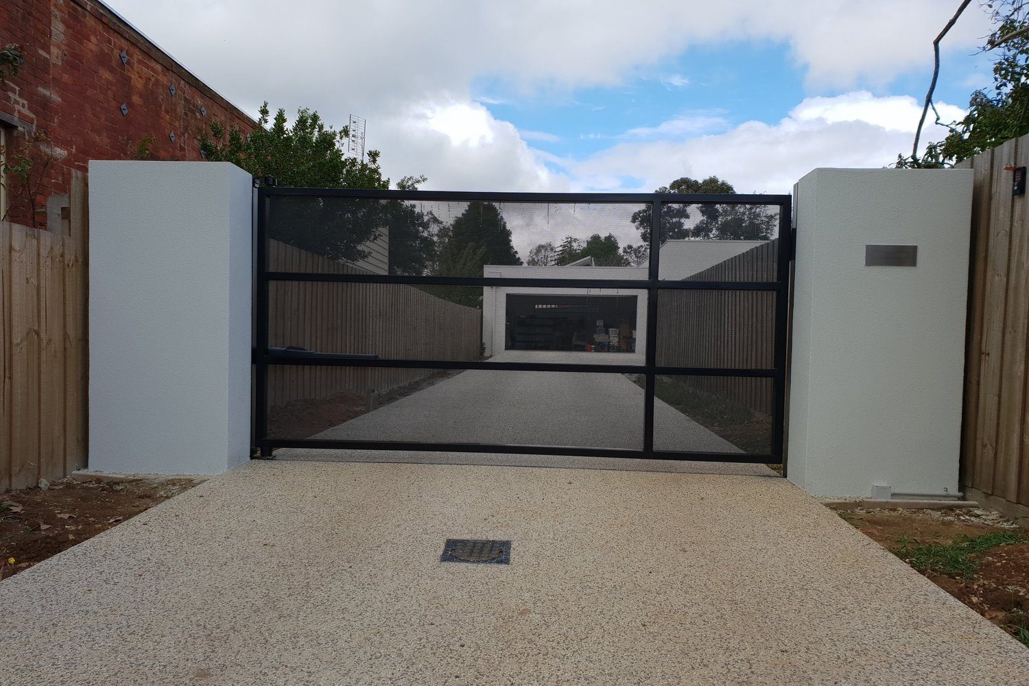 Metal swing gate on a residential driveway
