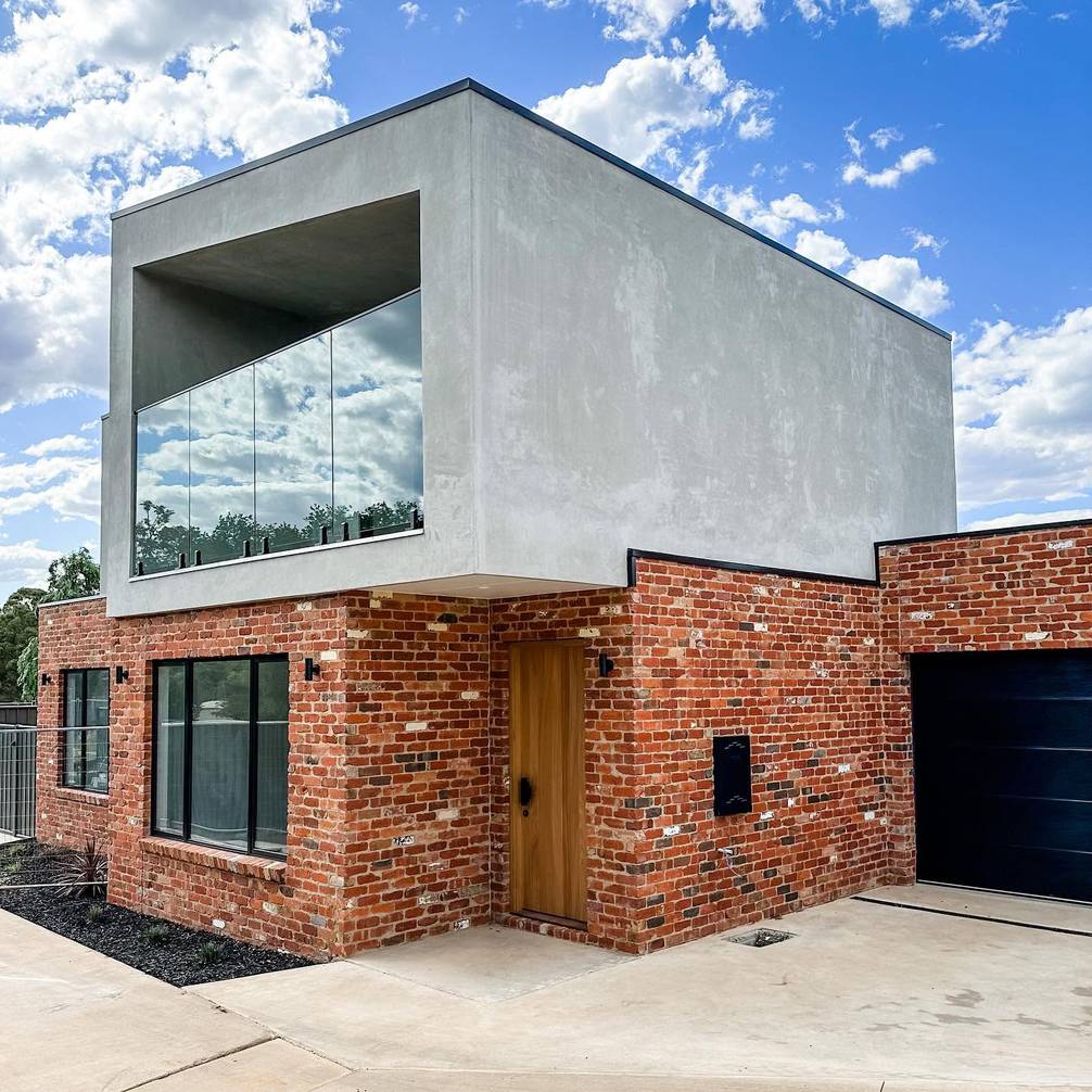 Dark sectional garage door on a modern brick and concrete home