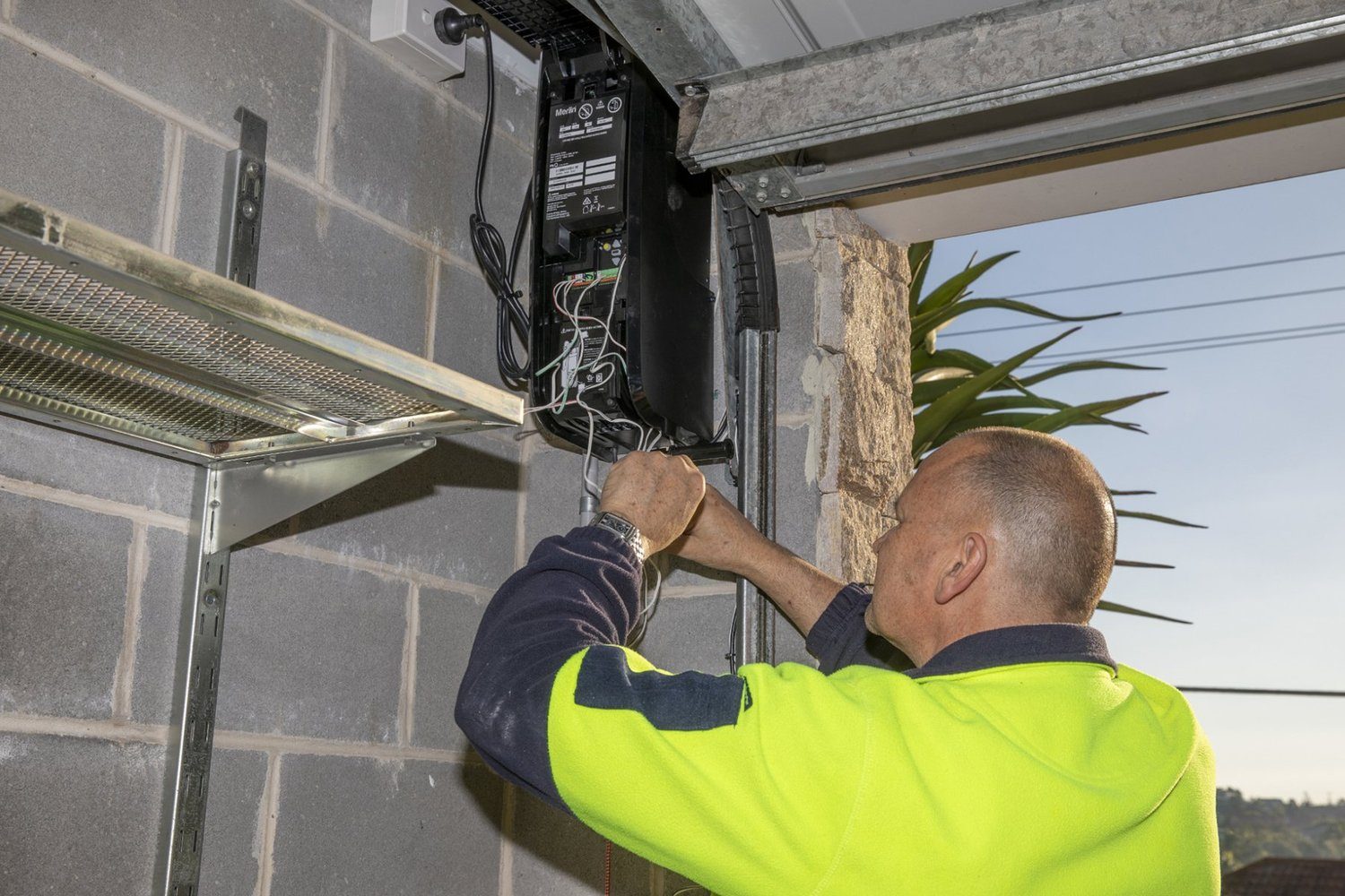Technician repairing a garage door